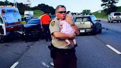 Jefferson County Sheriff's Deputy Ric Lindley is gaining widespread attention after a photo of him holding a baby girl after a crash was posted to Facebook. Jefferson County Sheriff's Deputy Ric Lindley is gaining widespread attention after a photo of him holding a baby girl after a crash was posted to Facebook.