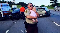 Jefferson County Sheriff&apos;s Deputy Ric Lindley is gaining widespread attention after a photo of him holding a baby girl after a crash was posted to Facebook.