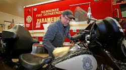 Bill Davidson, vice president of the Harley-Davidson Museum, washes a Milwaukee police motorcycle as other employees wash fire department vehicles in Milwaukee, Wisc. Harley-Davidson announced free Riding Academy motorcycle training to all U.S. first responders from January 1 to December 31, 2016.