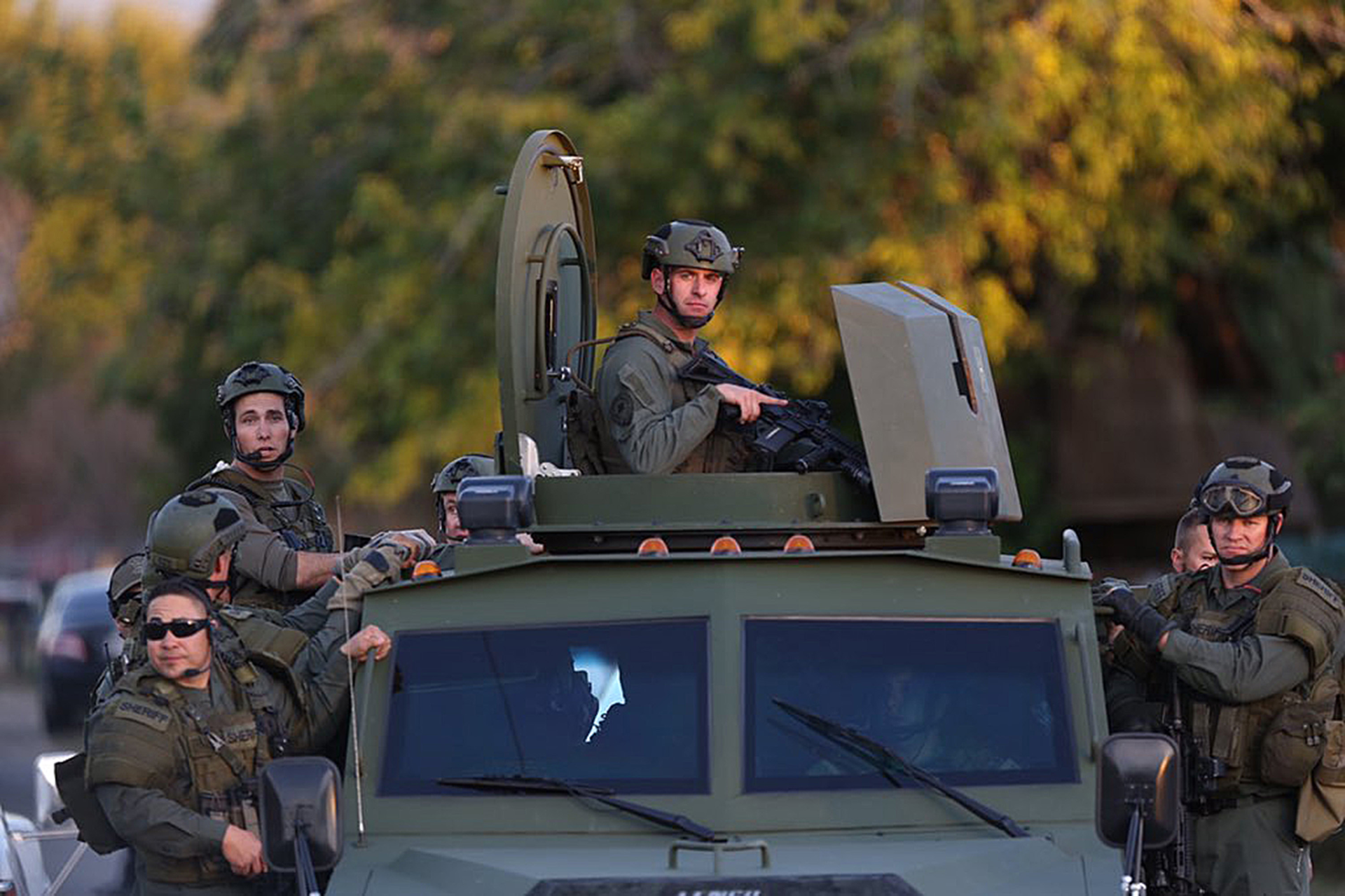 Officers swarm the scene near where suspects were shot following a mass shooting in San Bernardino, Calif., on Dec. 2.