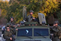 Officers swarm the scene near where suspects were shot following a mass shooting in San Bernardino, Calif., on Dec. 2. Officers swarm the scene near where suspects were shot following a mass shooting in San Bernardino, Calif., on Dec. 2.