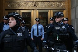 Chicago Police officers block an entrance to City Hall during a Justice for Laquan protest on Dec. 9.