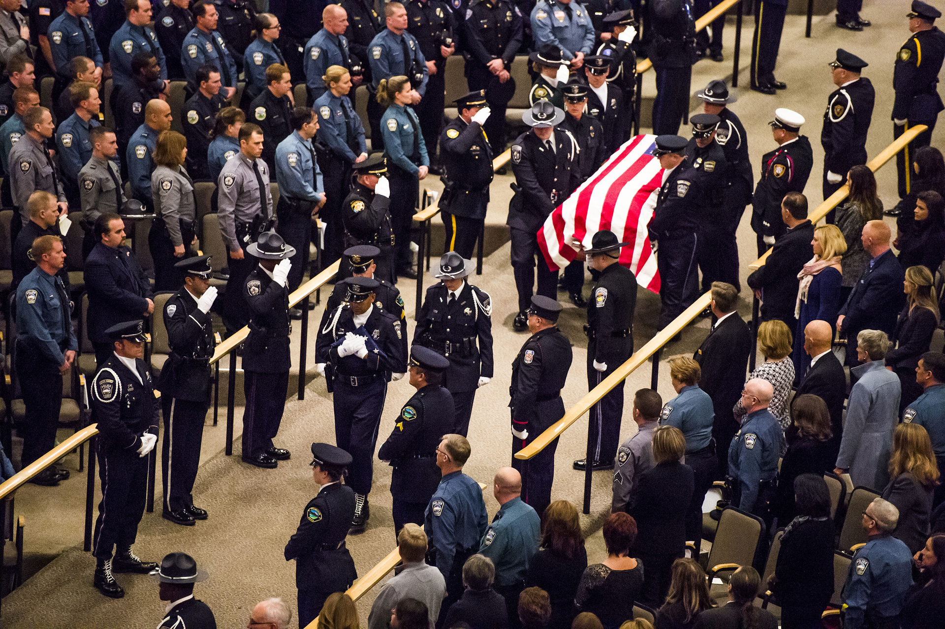 The Colorado Springs Police Honor Guard carries in the casket of Garrett Swasey, the 44-year-old University of Colorado at Colorado Springs police officer and six-year veteran of the department, during the funeral service at New Life Church on Dec. 4 in Colorado Springs, Colo.