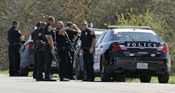Officers gather on Longvue Avenue in Fort Worth, Texas, on March 15 on the edge of the field where a suspect fled after a Fort Worth officer was shot in a gun battle with a two suspects. Officers gather on Longvue Avenue in Fort Worth, Texas, on March 15 on the edge of the field where a suspect fled after a Fort Worth officer was shot in a gun battle with a two suspects.