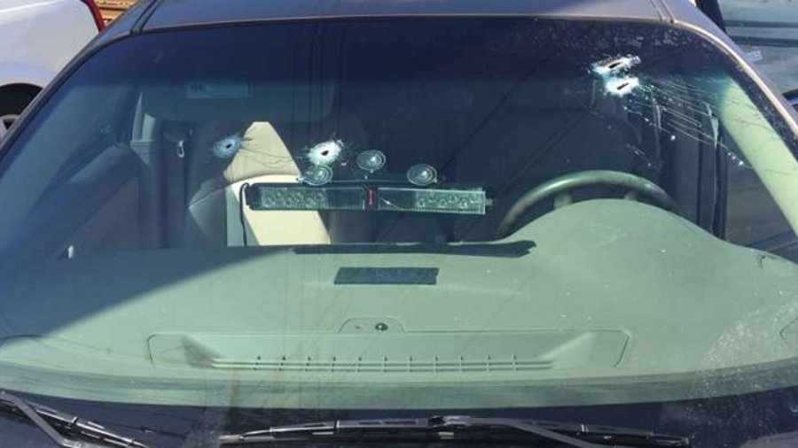 The window of an undercover Jacksonville Sheriff's narcotics detective's car was struck by several bullets as he was critically wounded Wednesday morning.