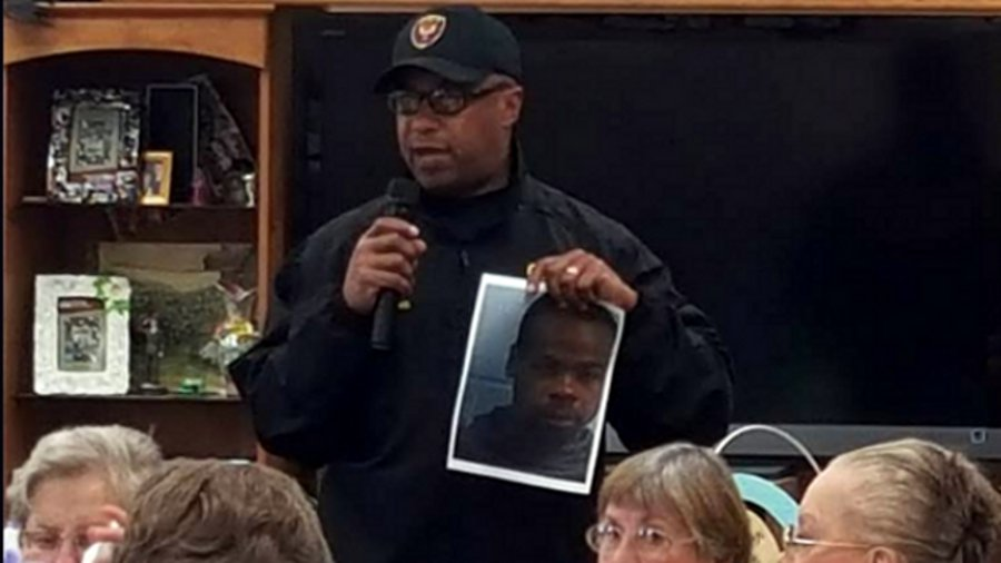 Vicksburg Police Chief Walter Armstrong shows residents a photo of escaped inmate Rafael McCloud.