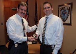 Sayreville police officer Matt Kurtz, pictured at right, receives his new rank of detective at a November ceremony. Sayreville police officer Matt Kurtz, pictured at right, receives his new rank of detective at a November ceremony.