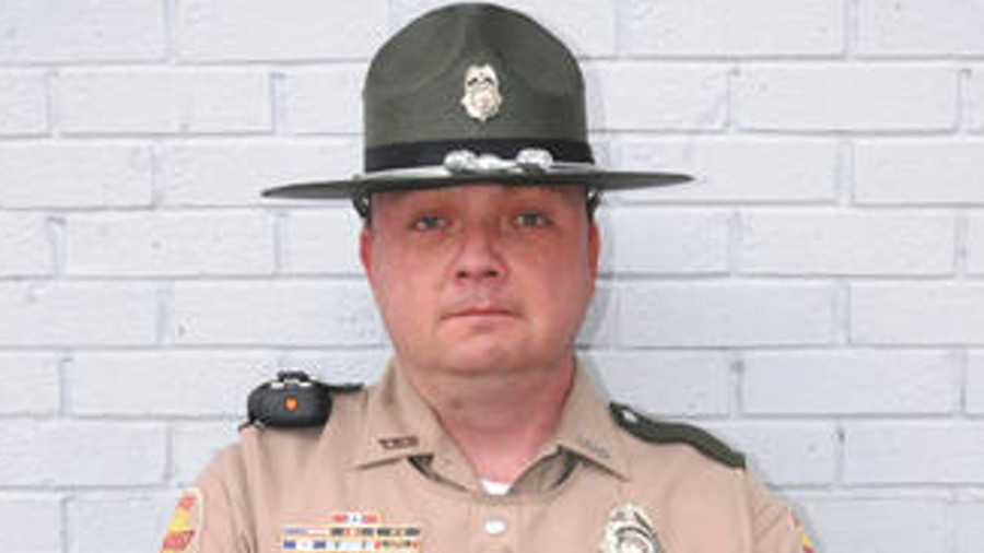 Trooper Grant Montgomery has been commended for helping save the life of a suspect wounded during a pursuit.