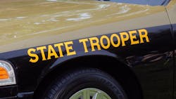 The trooper was investigating a previous crash when a second crash occurred nearby, sending one of the vehicles into his cruiser, trapping him inside.