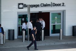 Dallas police investigate a domestic incident between a man and woman that took place outside Baggage Claim Door 3, resulting in an officer firing at the suspect, at Dallas Love Field airport on June 10.