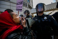 Anti-Trump protesters clash with the police outside the California Republican Convention on April 29.