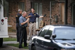 FBI evidence recovery team members search inside the Waldo Heights apartment complex at 8101 Campbell Street in Kansas City, Mo., on July 17.