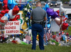 Police officer PJ Freeman stops to pay his respects at the roadside memorial for the three police officers slain in Baton Rouge, La., on July 20. Police officer PJ Freeman stops to pay his respects at the roadside memorial for the three police officers slain in Baton Rouge, La., on July 20.