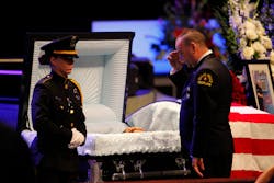 A Dallas Police Department chaplain salutes beside the casket of Senior Corporal Lorne Ahrens, one of five officers killed in last week's sniper attack, during his funeral at Prestonwood Baptist Church in Plano, Texas on July 13. A Dallas Police Department chaplain salutes beside the casket of Senior Corporal Lorne Ahrens, one of five officers killed in last week's sniper attack, during his funeral at Prestonwood Baptist Church in Plano, Texas on July 13.