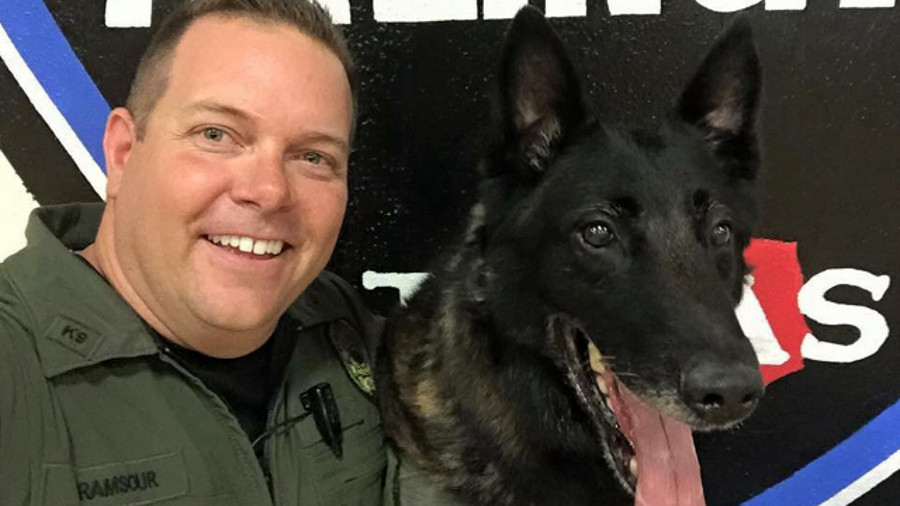 Arlington Police K-9 Handler Vince Ramsour, left, is seen with K-9 Mojo.