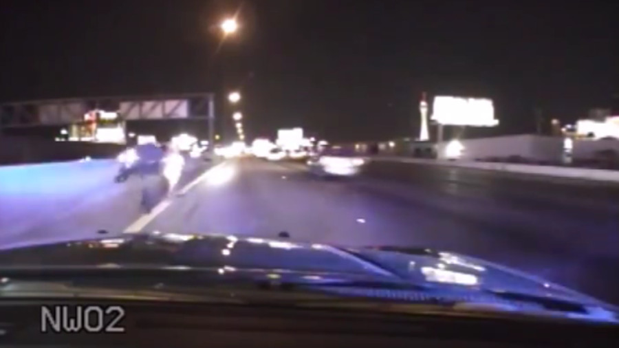 A Nevada Highway Patrol trooper is celebrated after pulling a distraught bikini-wearing woman from Interstate 15 traffic as she was about to be struck by a vehicle.