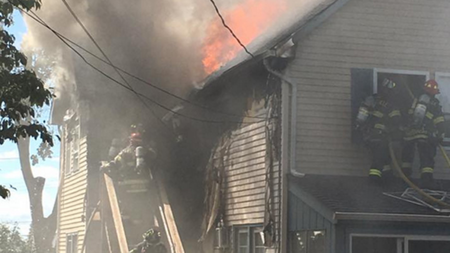 Sayreville Police Officer Brian Gay caught a 1-month old baby boy dropped from a fire and helped others escape the burning home Monday afternoon.
