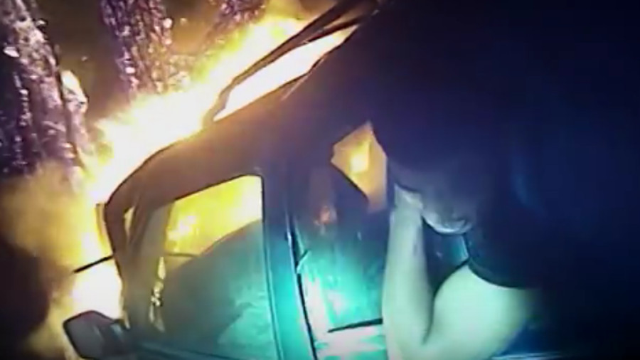 Newly released body camera video shows Athens-Clarke County Police Officer Dan Whitney heroically rush to a burning SUV and pull out a trapped passenger.