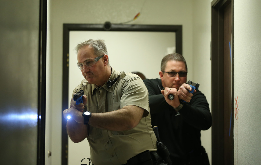 Las Vegas Metropolitan Police Department Patrol Detectives Steve Balonek, left, and Steve Thaxton enter a hallway in a building clearing scenario during 'Reality Based Training' at the Mojave Training Center.