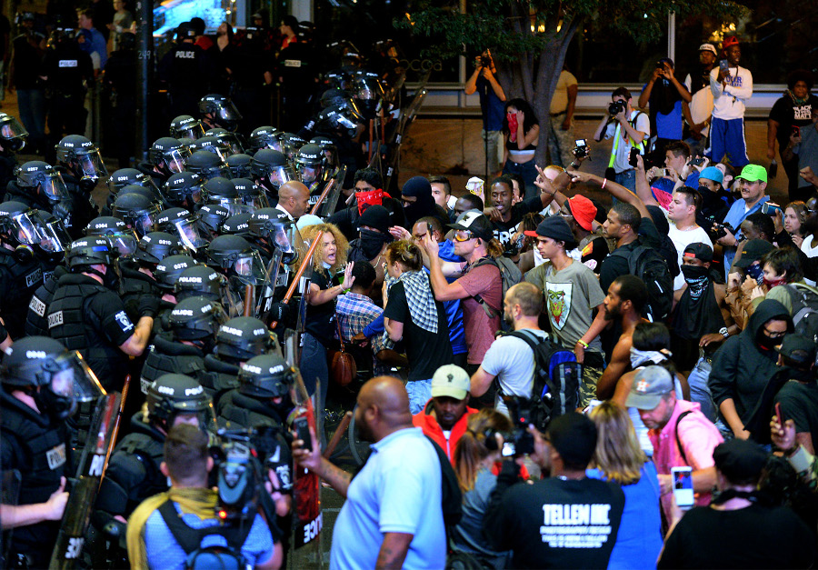 Charlotte police officers begin to move rioters down a street in Charlotte, N.C., on Sept. 21.