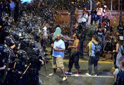 Debris fall upon Charlotte officers and protestors as officers began to push protestors from the intersection near the Epicentre on Sept. 21 in Charlotte, N.C.