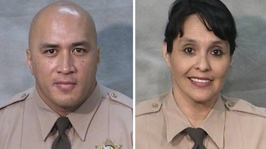 Corrections Officers Toamalama Scanlan, left, and Juanita Davila