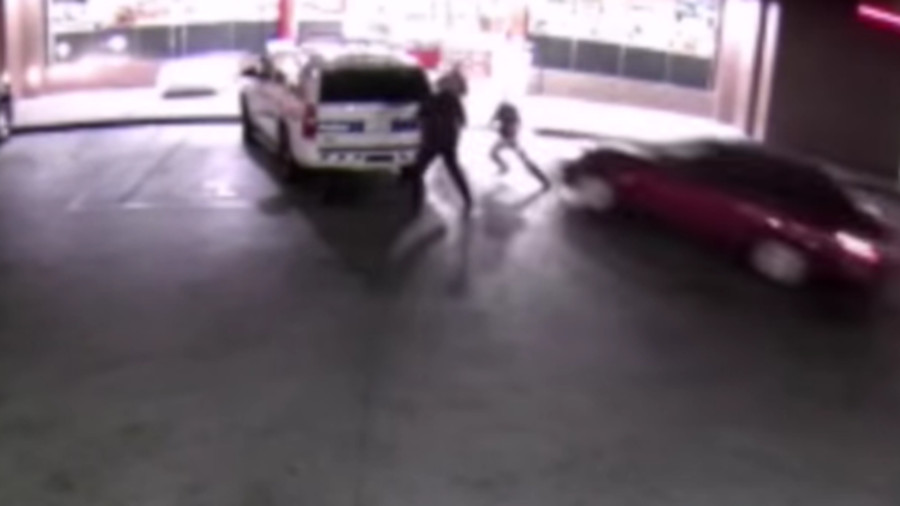 A suspect was arrested after intentionally driving through a group of Phoenix police officers as they stood outside a gas station early Tuesday morning.