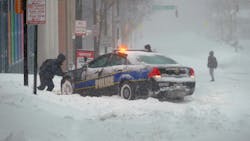 Andre Richardson of Baltimore helps a police officer try to get his cruiser out of snow in Baltimore on Jan. 23 during a powerful weekend storm blanketing the East Coast in snow. Andre Richardson of Baltimore helps a police officer try to get his cruiser out of snow in Baltimore on Jan. 23 during a powerful weekend storm blanketing the East Coast in snow.