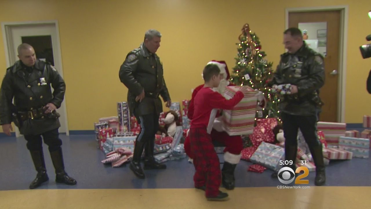 NYPD Officers Help Santa Deliver Gifts to Special Needs School