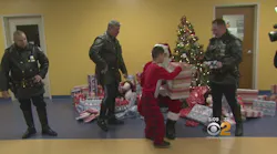 NYPD Officers Help Santa Deliver Gifts to Special Needs School