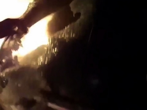 Raw: Officer Helps Woman Escape Burning Car