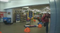 Officer Daniel Colwell tumbled through a display sign and opened fire on the suspect while still on the ground. Officer Daniel Colwell tumbled through a display sign and opened fire on the suspect while still on the ground.