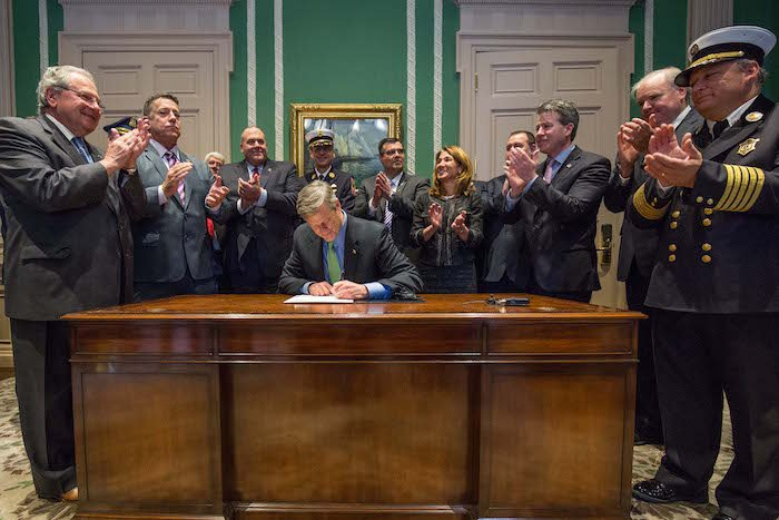 Gov. Charlie Baker on Tuesday signed a law that increases the benefit from $150,000 to $300,000 for families of law enforcement, fire and emergency services personnel killed in the line of duty.