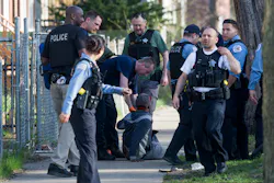 Members of the Chicago Police Department and Chicago Fire Department help a man who was shot on the 7200 block of South Green Street on April 16. Members of the Chicago Police Department and Chicago Fire Department help a man who was shot on the 7200 block of South Green Street on April 16.