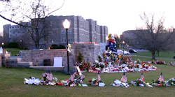 This photo, taken by our Editorial Director less than one week after the attack occurred, shows the memorials that were placed in front of and around the review stand on one side of the drill field / quad at Virginia Tech.