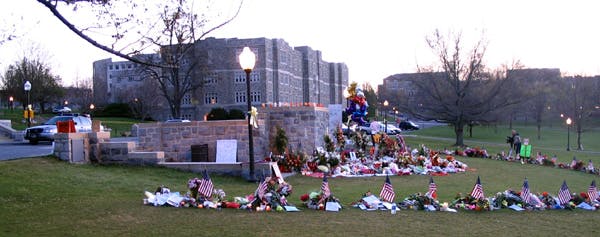 This photo, taken by our Editorial Director less than one week after the attack occurred, shows the memorials that were placed in front of and around the review stand on one side of the drill field / quad at Virginia Tech.