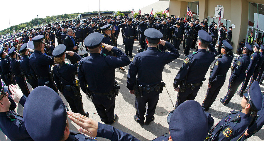 The family of officer Zamarippa arrives for the funeral, entering through a corridor of Dallas Police at Wilkerson-Greines Activity Center Saturday, July 16, 2016 in Fort Worth, Texas.