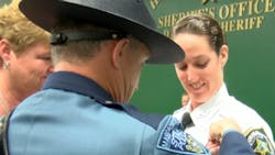 Newly graduated Hillsborough County Sheriff&apos;s Deputy Katelyn Kotfila has her badge pinned on by her father, who is a Massachusetts State Police trooper, and her mother.