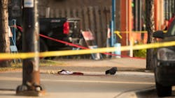 Evidence markers surround bloody clothes near the scene of a shooting at the intersection of West 24th Street and South Western Avenue, Sunday, September 17, 2017, on the Lower West Side of Chicago.