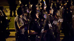 Police engage a mob after rocks and bottles were thrown by rioters during protests following a fatal police involved shooting the day before Sunday, Aug. 14, 2016, in Milwaukee, Wis.