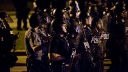 Police engage a mob after rocks and bottles were thrown by rioters during protests following a fatal police involved shooting the day before Sunday, Aug. 14, 2016, in Milwaukee, Wis. Police engage a mob after rocks and bottles were thrown by rioters during protests following a fatal police involved shooting the day before Sunday, Aug. 14, 2016, in Milwaukee, Wis.
