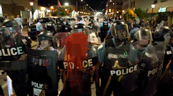 Police officers line up with shields along Delmar Boulevard in University City on Saturday, Sept. 16, 2017.