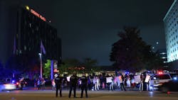 Protesters chant slogans as police officers stand guard at the Crowne Plaza Chicago O&apos;Hare Hotel &amp; Conference Center on September 13, 2017, in Rosemont, Ill.
