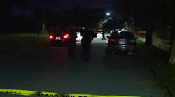 Two Detroit police officers sitting in their marked patrol car looking for stolen vehicles were ambushed by gunmen Wednesday night.