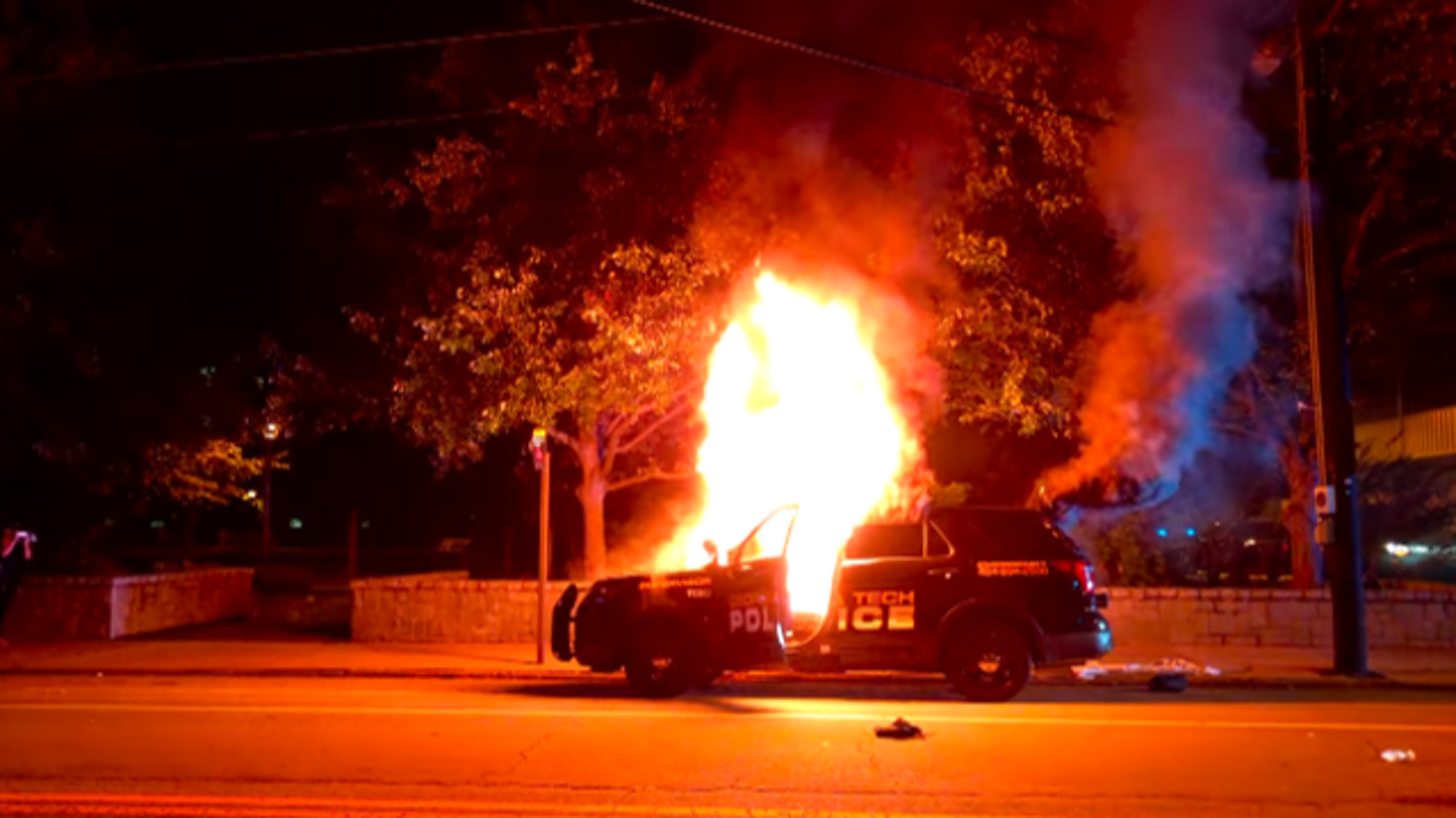 A Georgia Tech Police patrol car is seen on fire on Sept. 18 in Atlanta as violence breaks out during a vigil for a student fatally shot by an officer.