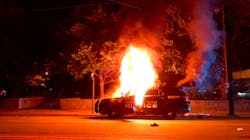 A Georgia Tech Police patrol car is seen on fire on Sept. 18 in Atlanta as violence breaks out during a vigil for a student fatally shot by an officer.