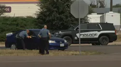 Two police officers were injured in an unusual incident involving a stolen vehicle and a police dog Tuesday.