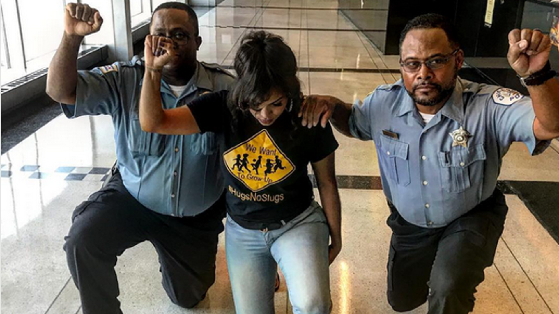 Activist Aleta Clark, who apparently asked two Chicago police officers to kneel with her in a photo posted to social media, may have inadvertently earned them reprimands.