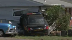A vehicle cut in front of a Franklin County Sheriff's patrol car Tuesday, causing a crash that ended up with the cruiser smashing into a house.