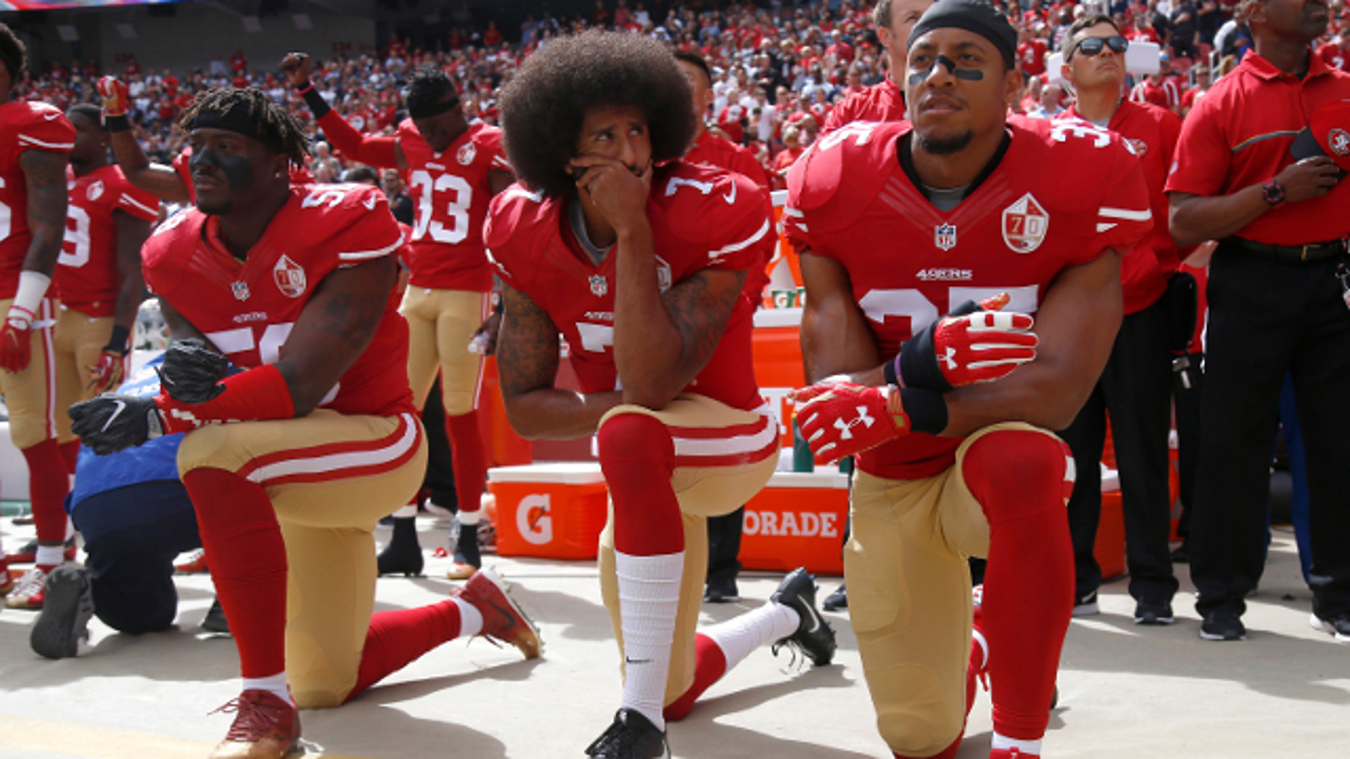 From left, San Francisco 49ers' Eli Harold (58), quarterback Colin Kaepernick (7) and Eric Reid (35) kneel during the national anthem before their NFL game against the Dallas Cowboys on Sunday, Oct. 2, 2016 in Santa Clara, Calif.